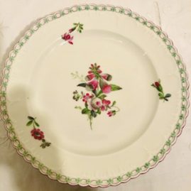 Set of fourteen KPM dinner plates with raised forget me nots around the borders