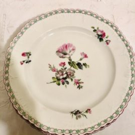 Set of fourteen KPM dinner plates with raised forget me nots around borders