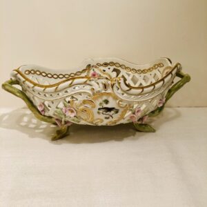 This KPM bowl is decorated with reticulation and raised pink flowers