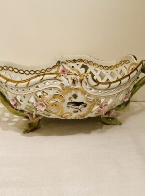 This KPM bowl is decorated with reticulation and raised pink flowers