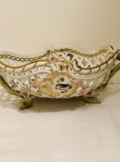 This KPM bowl is decorated with reticulation and raised pink flowers
