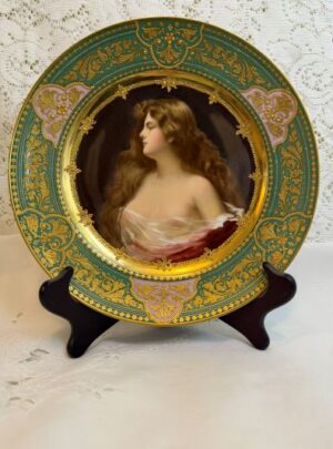Cabinet portrait plate that has a central painting of a beautiful lady with long flowing hair.