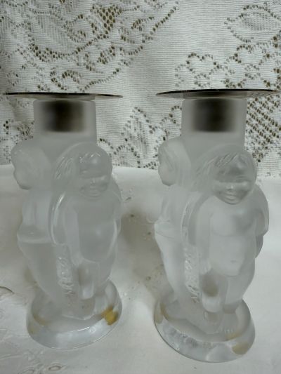 pair of Lalique iridescent Angelot candlesticks, where there are three figural decorative angels on each candlestick