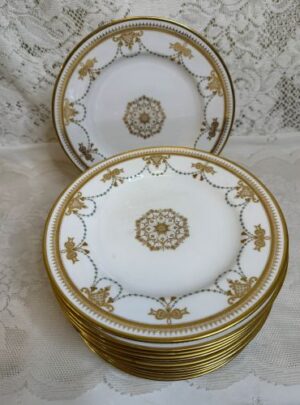 Set of 11 Copeland Spode dessert plates which have a border of garlands of aqua enamel jewels and gold bows