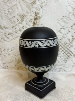 Wedgwood jasperware urn which has a figural cherub on the cover