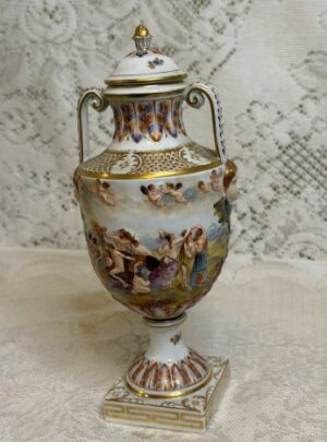 Capodimonte urn which has outstanding detailed raised figural scenes all around the urn