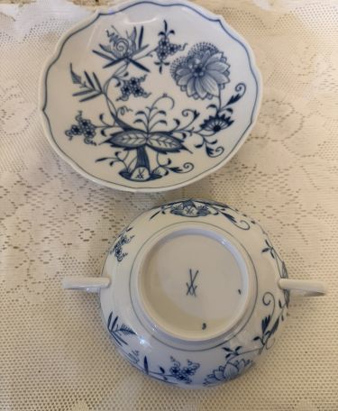 Set of eight rare cream soup bowls and saucers each having two handles.